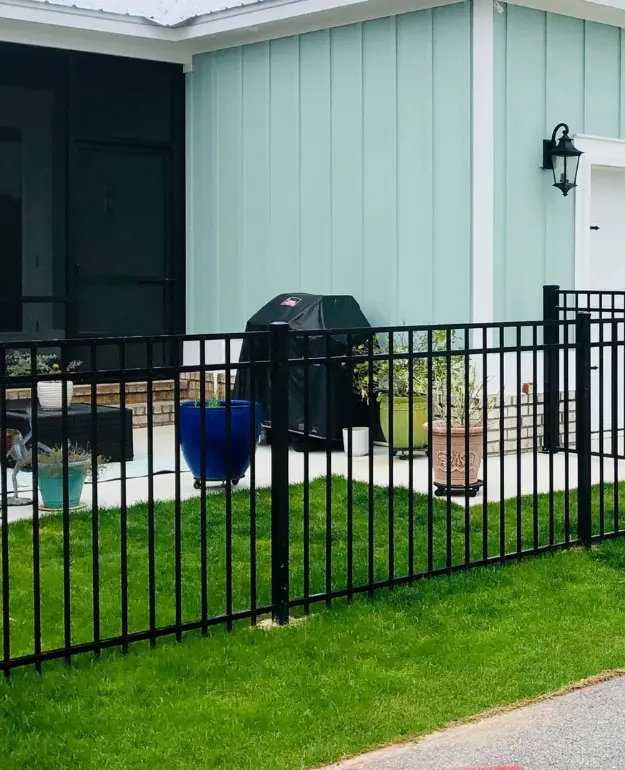 house patio with aluminum fence and outdoor grill